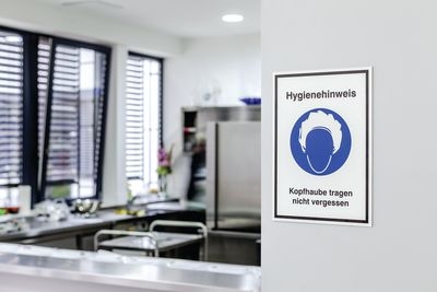 Kombinationsschild mit Gebotszeichen und Text für Kopfhaube tragen im Hygienebereich